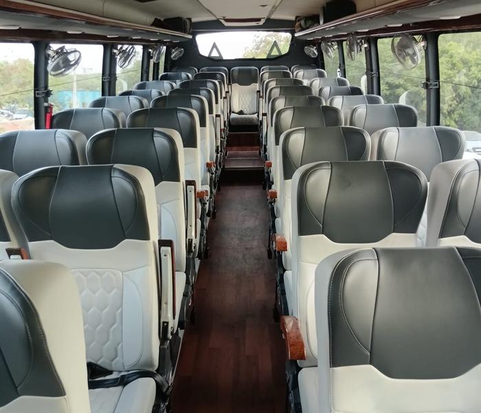 Interior of a Pal Tour & Travels luxury coach with reclining leather seating and polished flooring